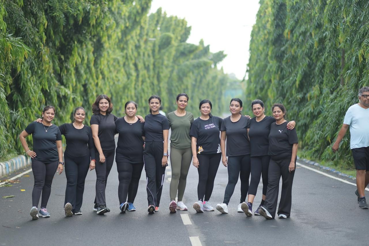 The Parivartan community, arm in arm on their morning avenue with Kanchan