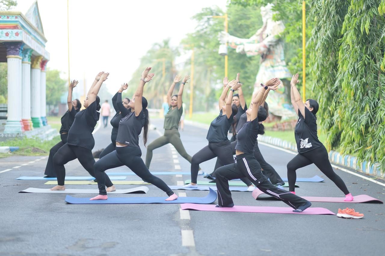 The Parivartan community in a synchronized warrior pose on their morning avenue